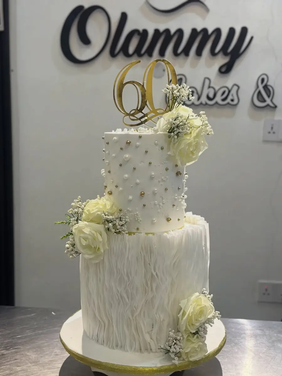 White and gold 60th birthday cake with wafer paper flowers